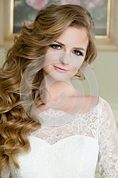 Portrait of beautiful blonde Bride with wedding makeup and hairstyle