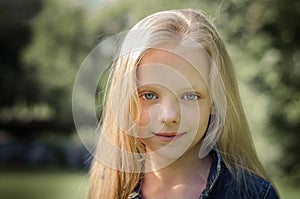 Portrait of a beautiful blonde little girl with long hair.
