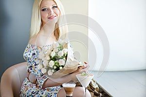 Portrait of a beautiful blonde smiling with flowers