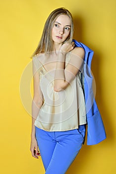 Portrait of the beautiful blonde woman in blue costume.