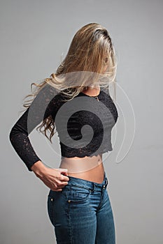 Portrait of a beautiful blonde woman hiding behind her hair