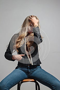 Portrait of a beautiful blonde woman hiding behind her hair