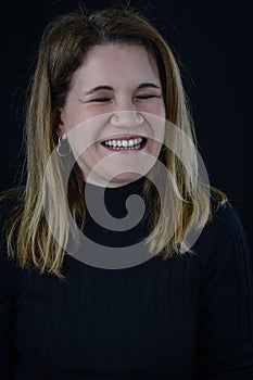 portrait of a beautiful blonde woman laughing cheerfully spontaneously and honestly