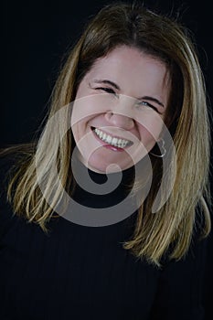 portrait of a beautiful blonde woman laughing cheerfully spontaneously and honestly photo