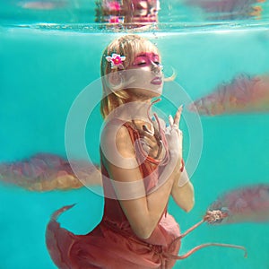 Portrait of beautiful blonde woman with pink flamingo