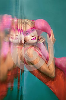 Portrait of beautiful blonde woman with pink flamingo