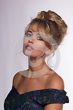 Portrait of a beautiful blonde woman in retro dress 50-s style .