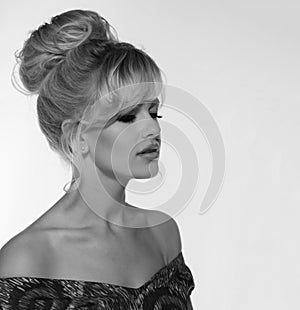 Portrait of a beautiful blonde woman in retro dress 50-s style . monochrome black and white photo