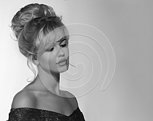 Portrait of a beautiful blonde woman in retro dress 50-s style . monochrome black and white photo