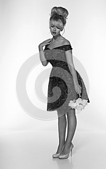 Portrait of a beautiful blonde woman in retro dress 50-s style . monochrome black and white photo