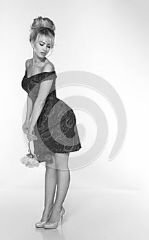 Portrait of a beautiful blonde woman in retro dress 50-s style . monochrome black and white photo