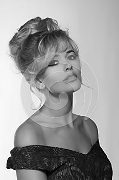 Portrait of a beautiful blonde woman in retro dress 50-s style . monochrome black and white photo