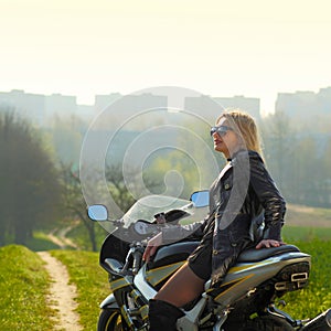 Portrait of a beautiful blonde woman on a sports motorcycle