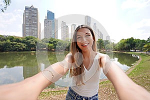 Portrait of beautiful Brazilian girl takes selfie in Areiao Park in Goiania, Goias, Brazil