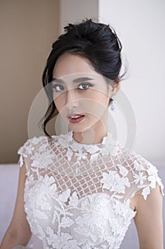 Portrait of beautiful bride with beautiful hairstyle. Makeup artist working with young bride. Gorgeous bride with fashion makeup.