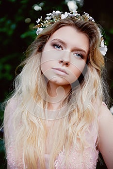 Portrait of beautiful bride blonde in pink lace dress in the hair ornament handmade.Big facial