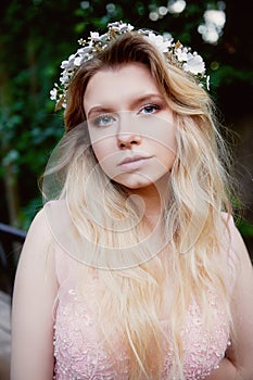 Portrait of beautiful bride blonde in pink lace dress in the hair ornament handmade.Big facial