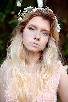 Portrait of beautiful bride blonde in pink lace dress in the hair ornament handmade.Big facial