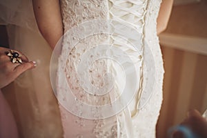 Portrait of beautiful bride with fashion veil and dress at wedding morning