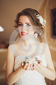 Portrait of beautiful bride with fashion veil and dress at wedding morning