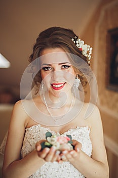 Portrait of beautiful bride with fashion veil and dress at wedding morning