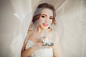 Portrait of beautiful bride with fashion veil and dress at wedding morning