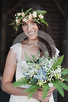 Portrait of beautiful bride with green flowers
