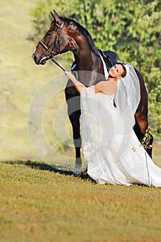 Portrait of beautiful bride with horse