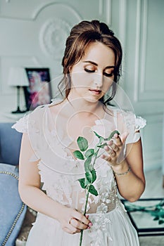 Portrait of a beautiful bride in a white negligee.