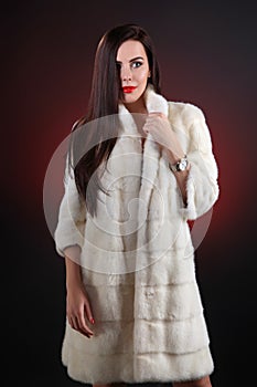 Portrait beautiful brunette in fur coat from mink