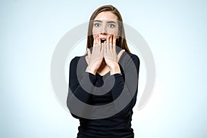 Portrait of a beautiful brunette girl with a surprised look