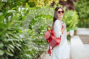 Portrait of beautiful brunette girl walking down the street.