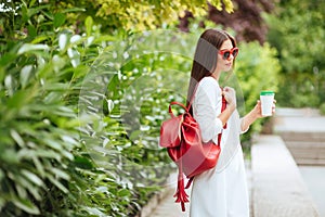 Portrait of beautiful brunette girl walking down the street.