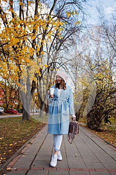 Portrait of beautiful brunette girl walking down the street