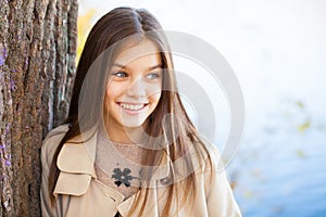 Portrait of a beautiful brunette little girl, autumn park outdoors