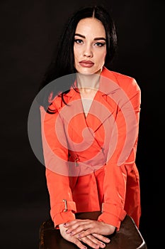 portrait of a beautiful brunette woman in a red dress cloak