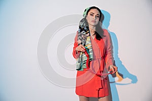 portrait of a beautiful brunette woman in a red dress cloak