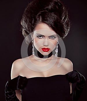 Portrait of beautiful brunette woman with red lips over dark