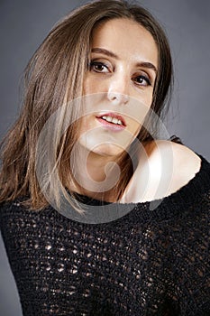Portrait of a beautiful brunette woman wearing knitted or crocheted pullover with lace
