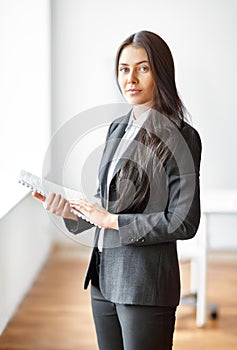 Portrait of beautiful business woman with documents in the