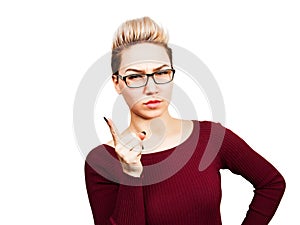 Portrait of beautiful business woman in glasses showing finger up. Isolated on white background