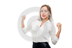 Portrait of beautiful business woman holding fists like winning