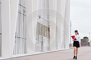 Portrait of beautiful business woman holding notebook on her way to work