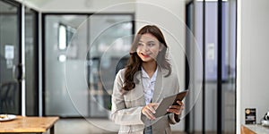 Portrait beautiful business woman holding tablet computer in office