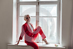 Portrait of a beautiful business woman in a red business suit in the office