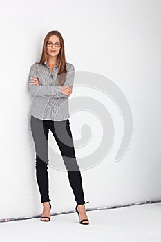 Portrait of beautiful business woman standing against white wall