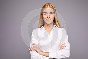 Portrait of beautiful business woman standing with hands folded and looking at camera over white background