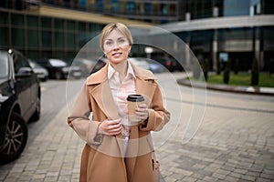 Portrait of a beautiful businesswoman with coffee near the business center