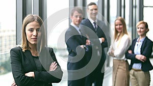 Portrait of beautiful businesswoman smiling, colleagues in background