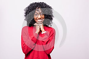 Portrait of beautiful casually dressed african young woman in round glasses having doubtful expression, looking away in